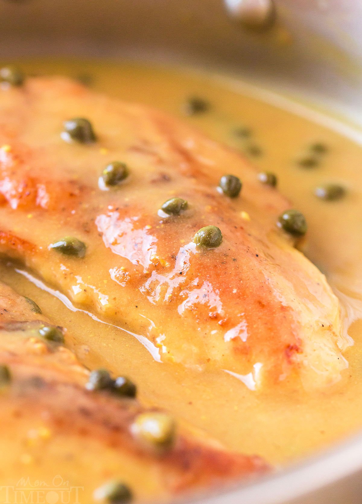 chicken piccata in a skillet with lemon caper sauce ready to be served.