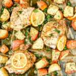 greek chicken prepared on sheet pan with lemons potatoes and parsley