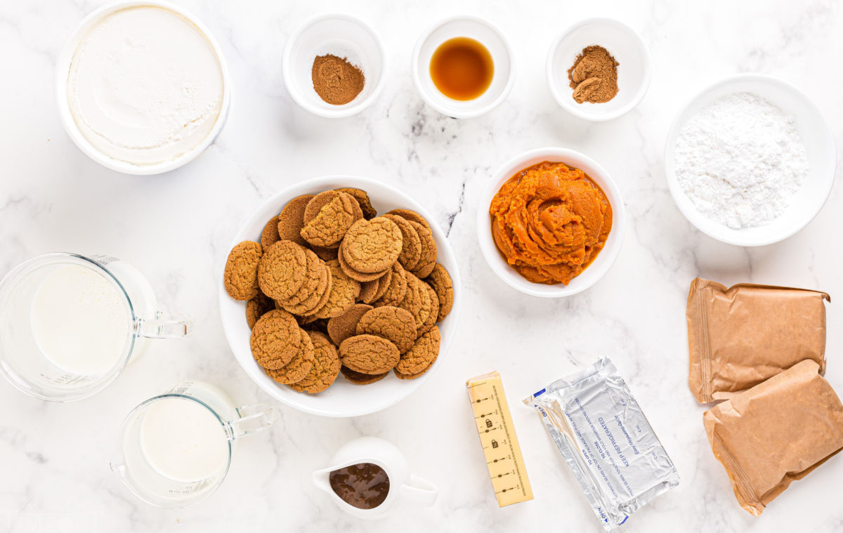 pumpkin lasagna ingredients measured out into small bowls sitting on white surface