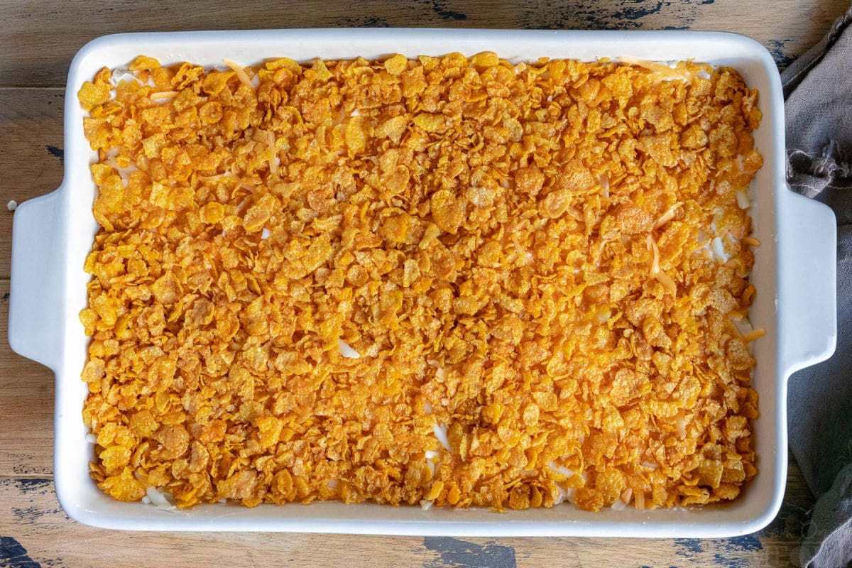 top down view of cheesy potatoes about to go in the oven with cornflake topping