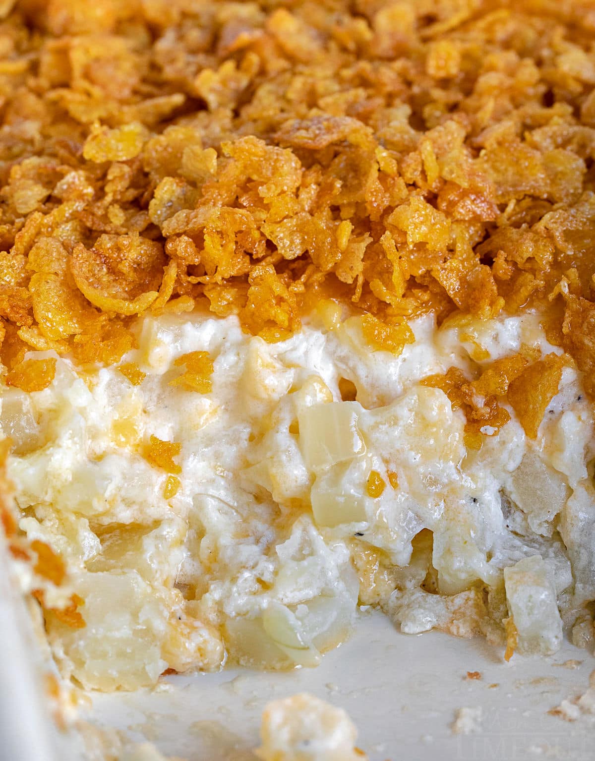 close up look at cheesy potatoes in casserole dish