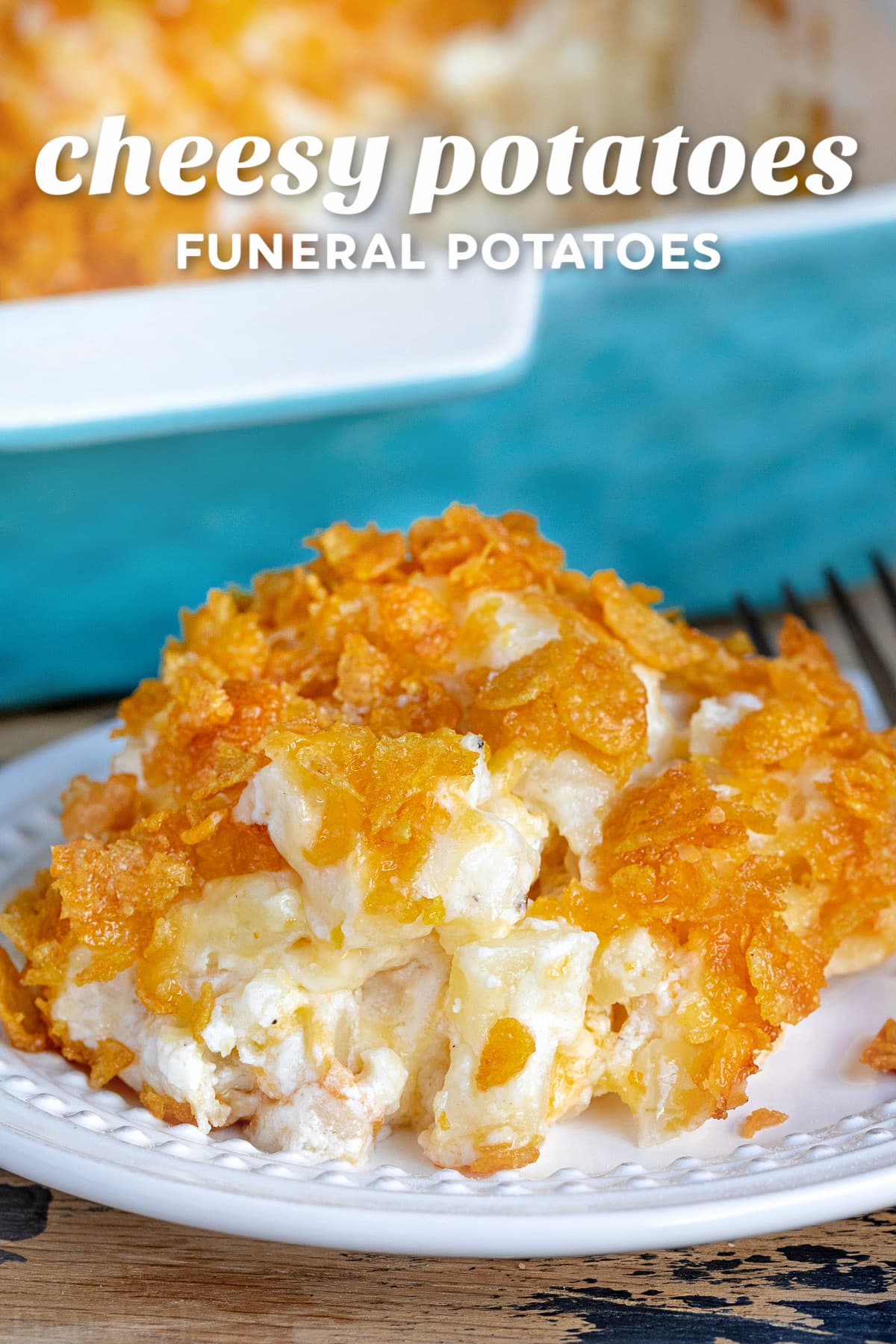 cheesy potatoes on a white plate with casserole dish in background and title overlay at top