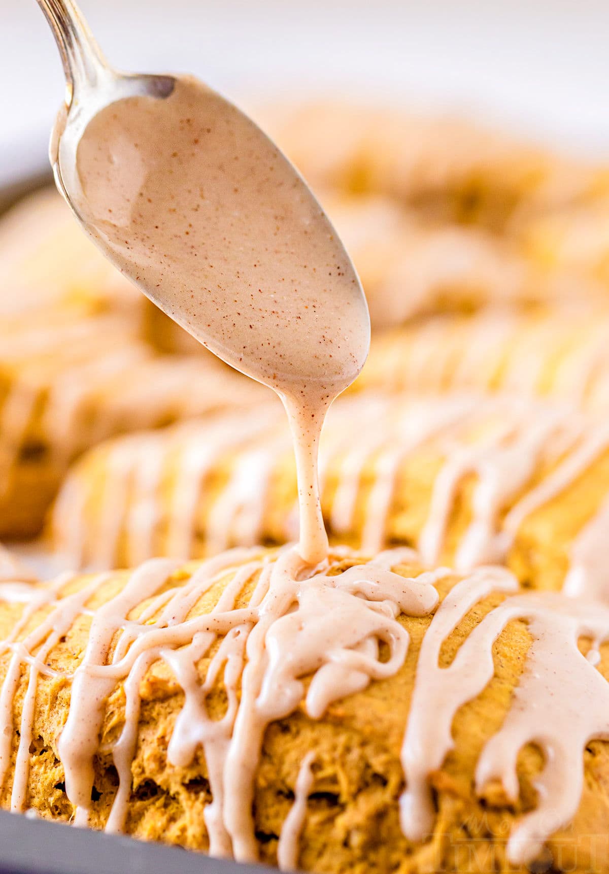 maple cinnamon glaze being drizzled on scones