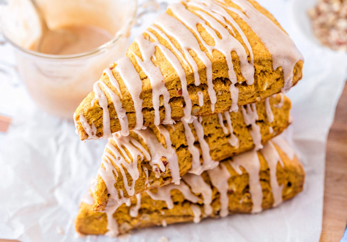 pumpkin scones stacked top down view with a maple glaze drizzled on top