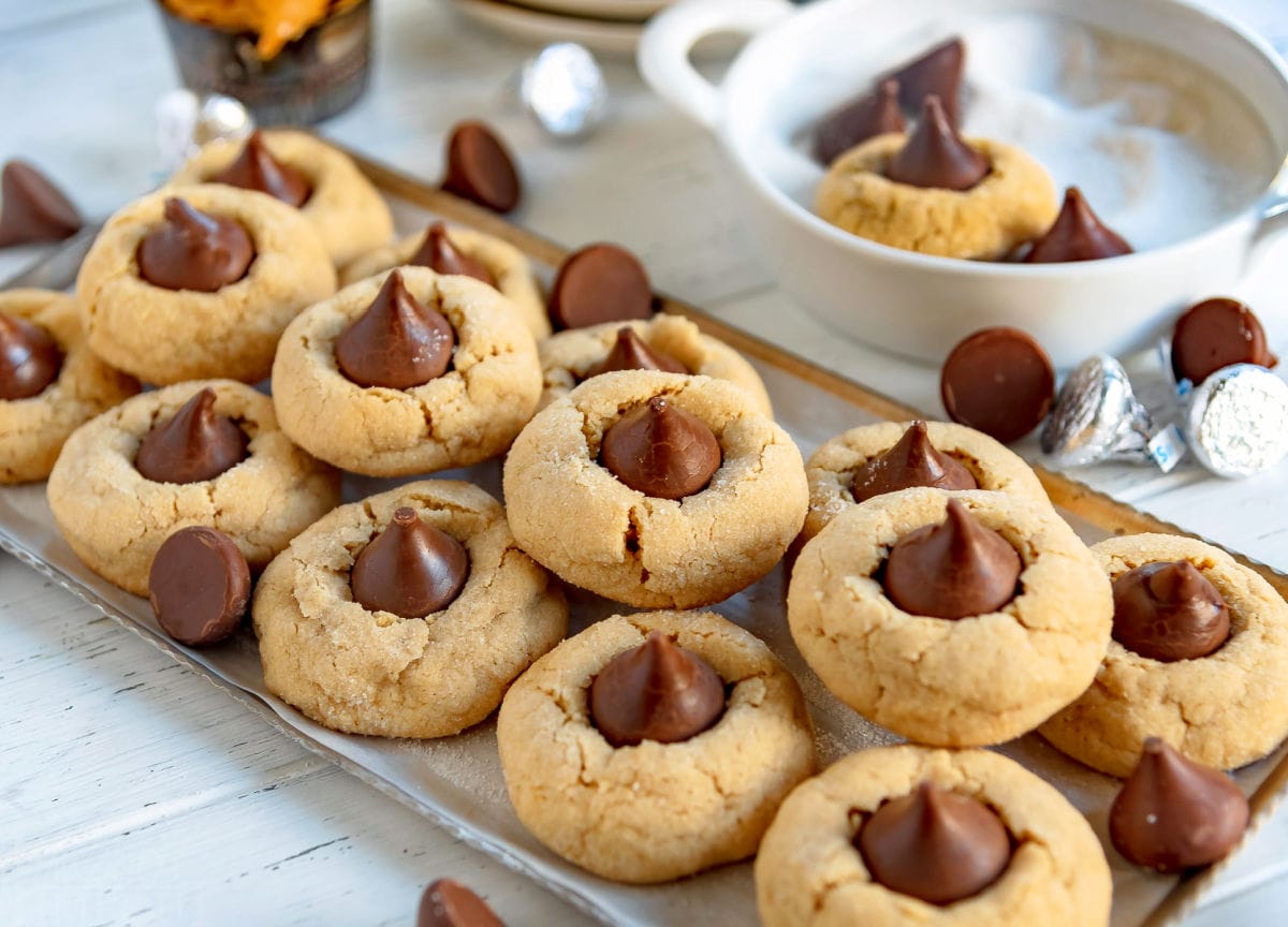 front view of peanut butter blossoms stacked on metal serving tray