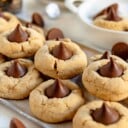 peanut butter blossoms stacked on metal serving tray