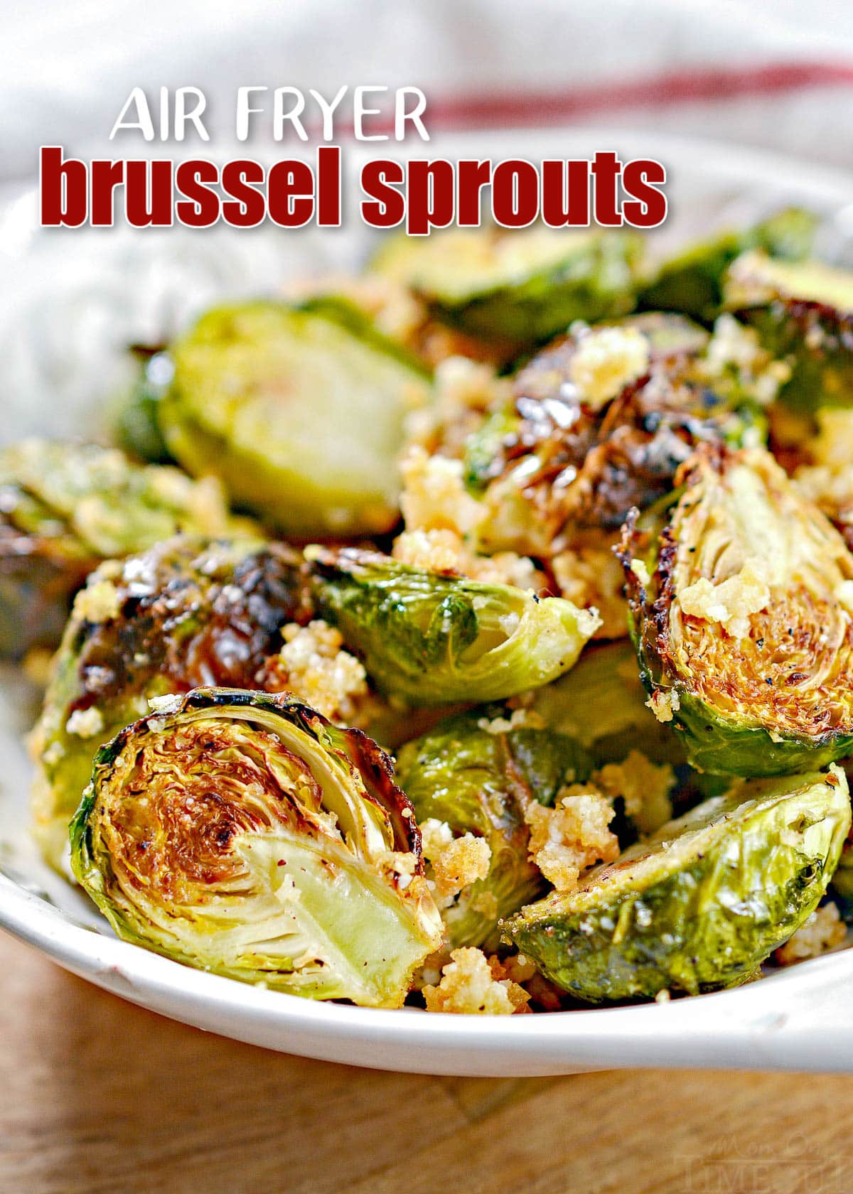 air fryer brussel sprouts in white bowl seasoned with garlic and Parmesan and title overlay at top of image