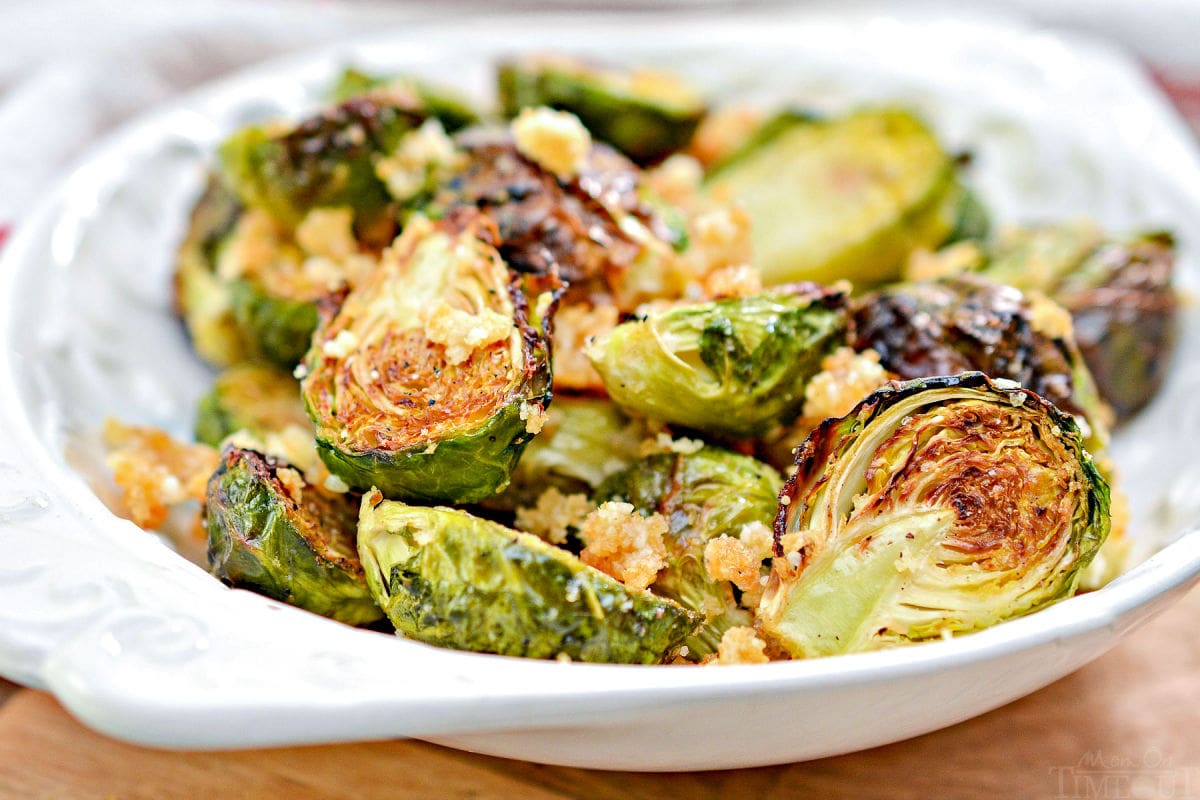 brussels sprouts in white shallow bowl made in air fryer with parmesan and garlic