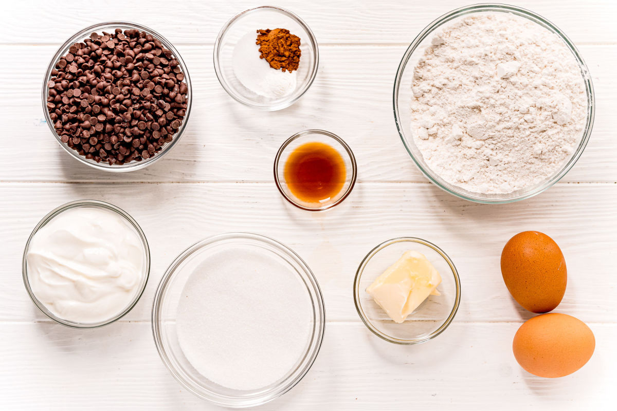 muffin ingredients measured out into small glass bowls on white surface