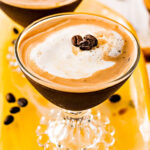 espresso martini recipe in two glasses on yellow glass tray top down view square