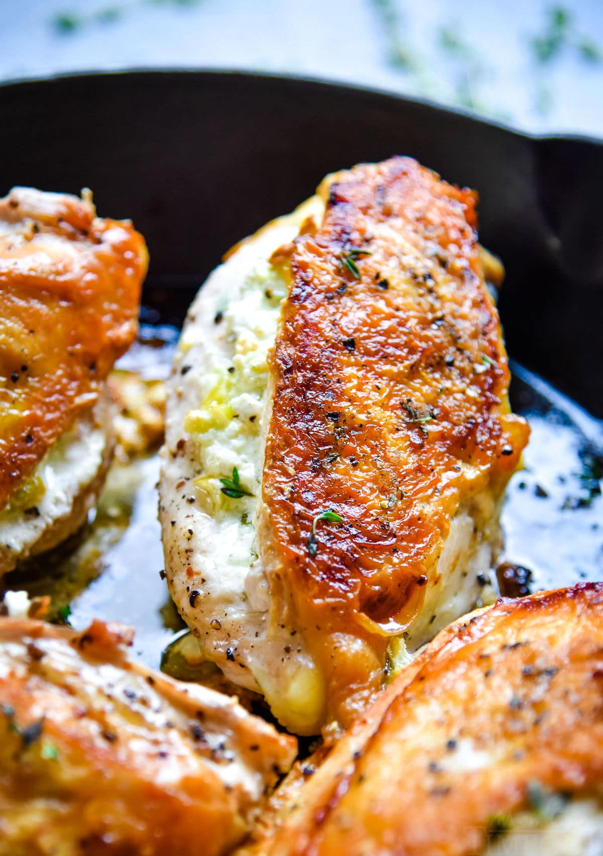 pan seared chicken in cast iron skillet stuffed with goat cheese