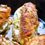 pan seared chicken in cast iron skillet stuffed with goat cheese