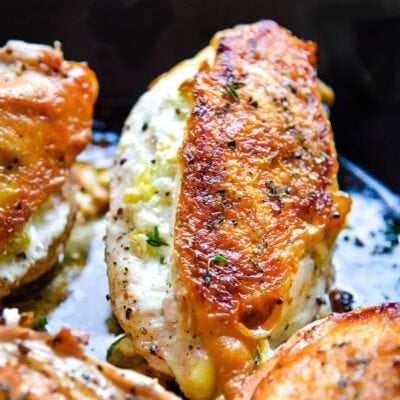 pan seared chicken in cast iron skillet stuffed with goat cheese