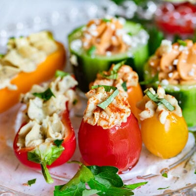 plate of hummus stuffed veggies drizzled with olive oil