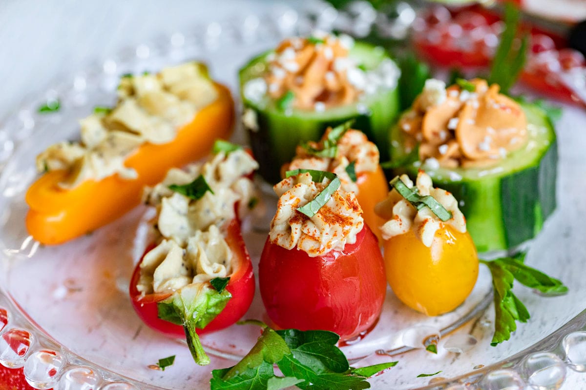 plate of hummus stuffed veggies drizzled with olive oil