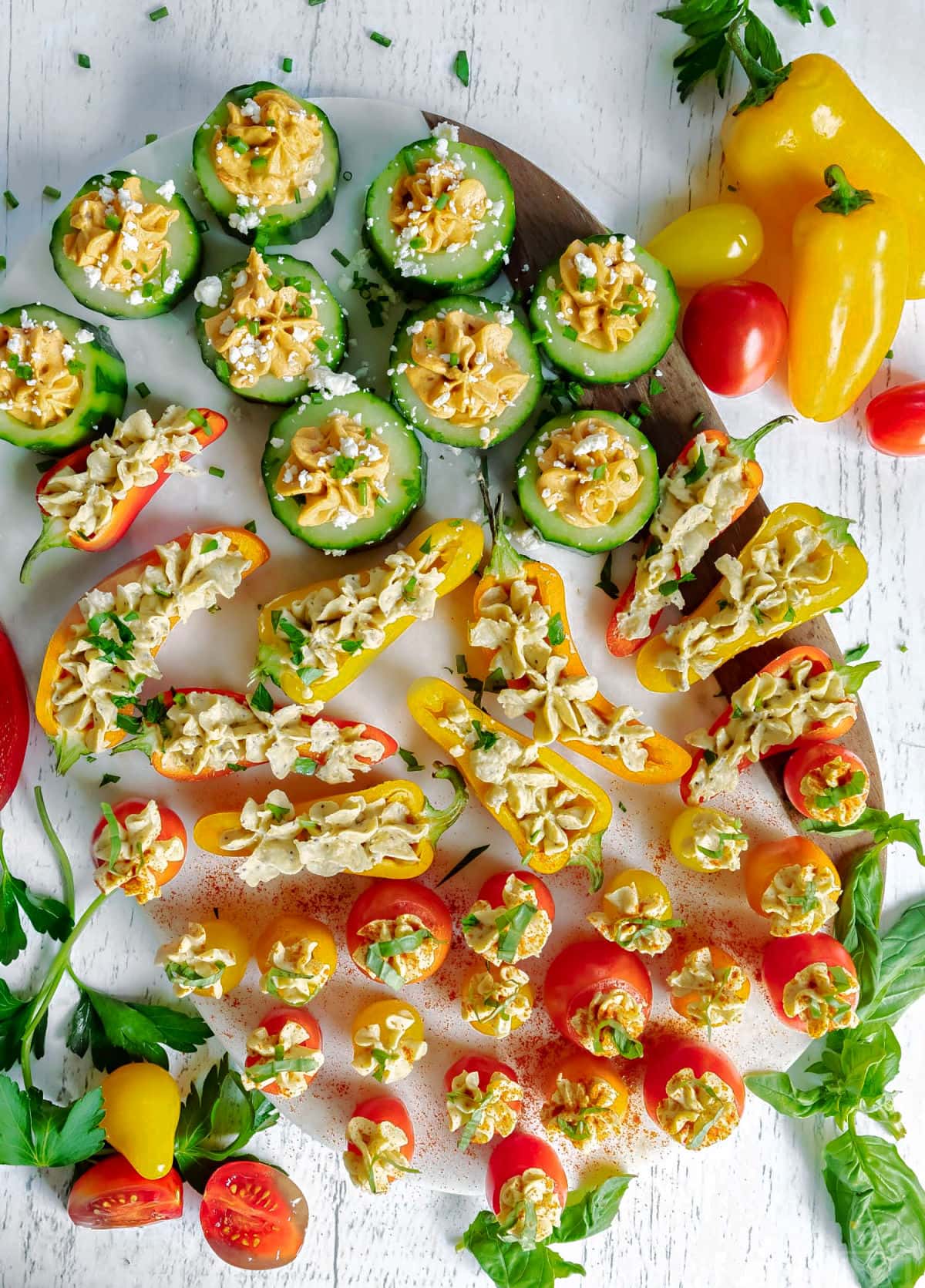 top down look at veggies stuffed with hummus and topped with herbs