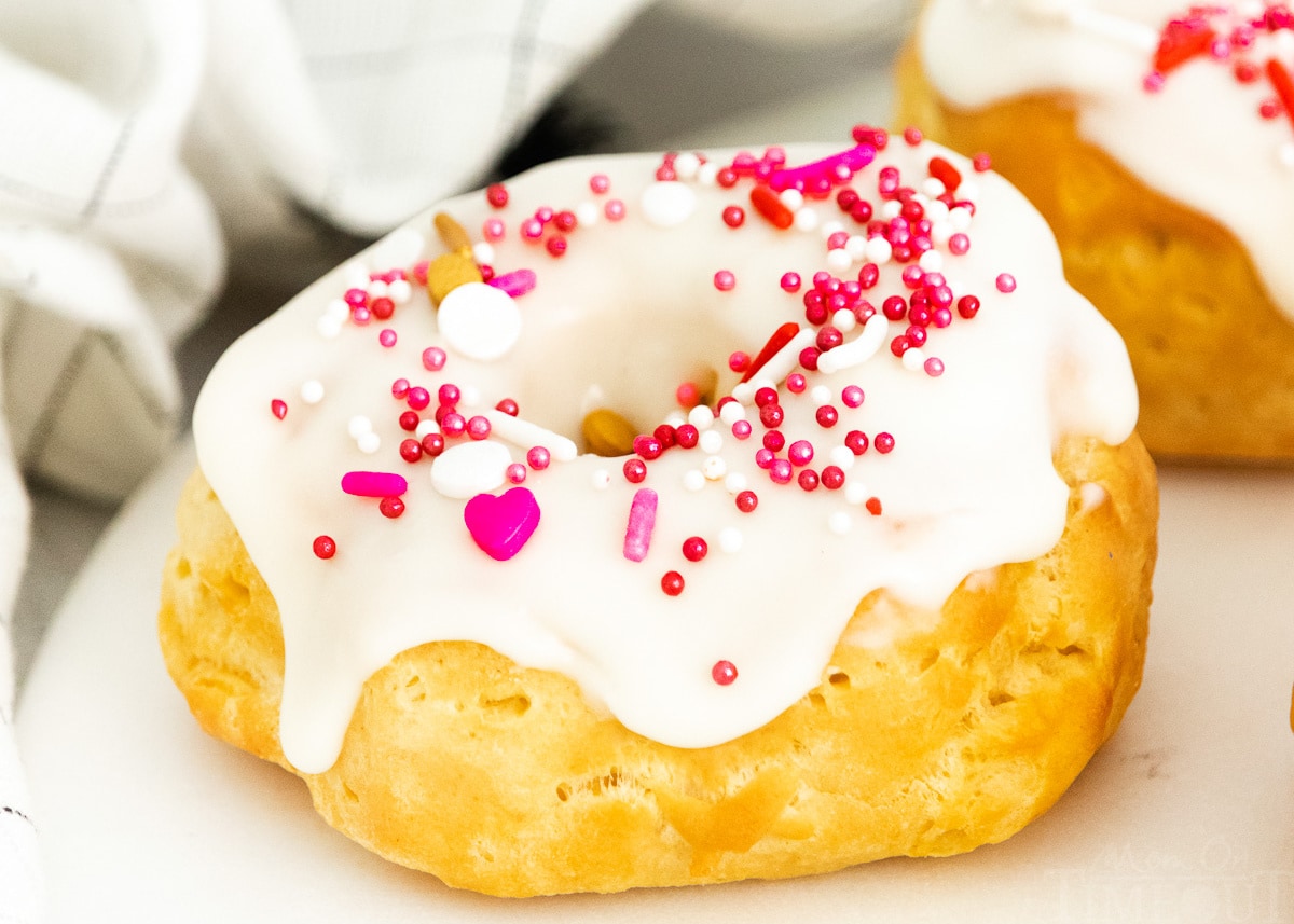 air fryer biscuit donut topped with vanilla glaze and sprinkles