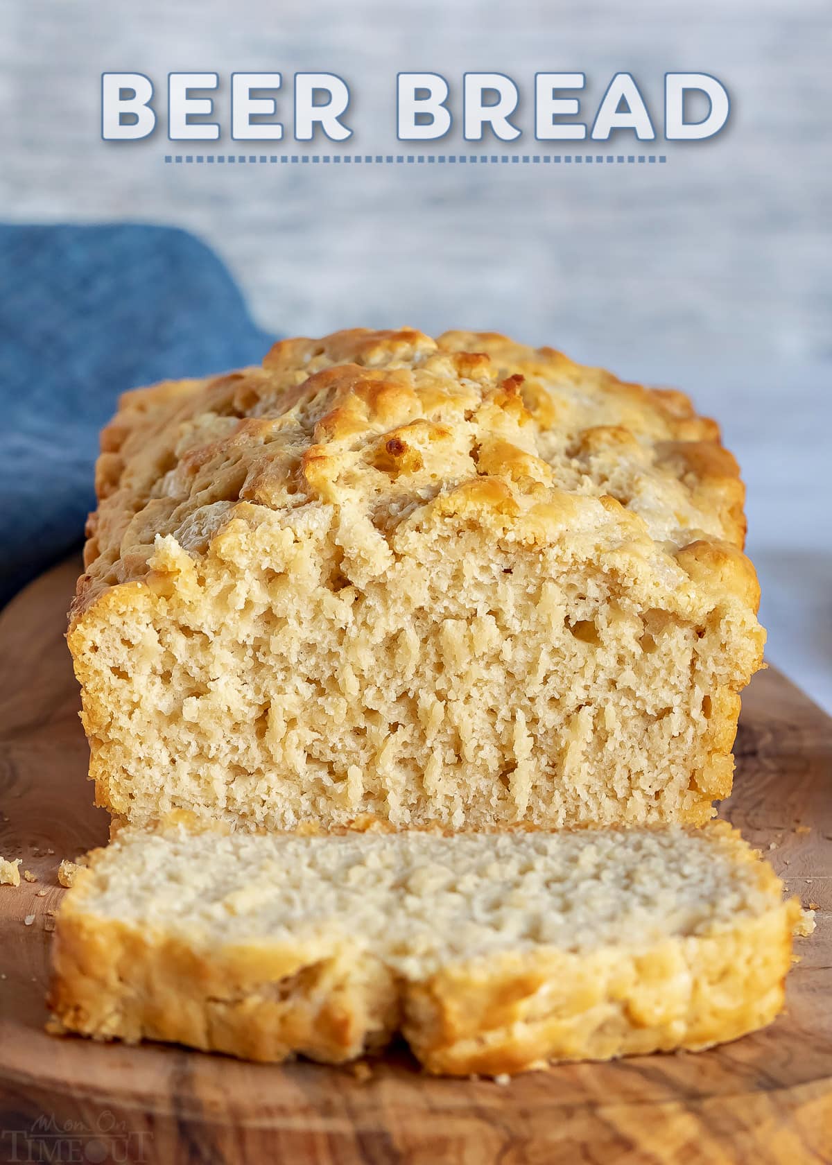 beer bread sitting on board with one slice and text overlay at top.