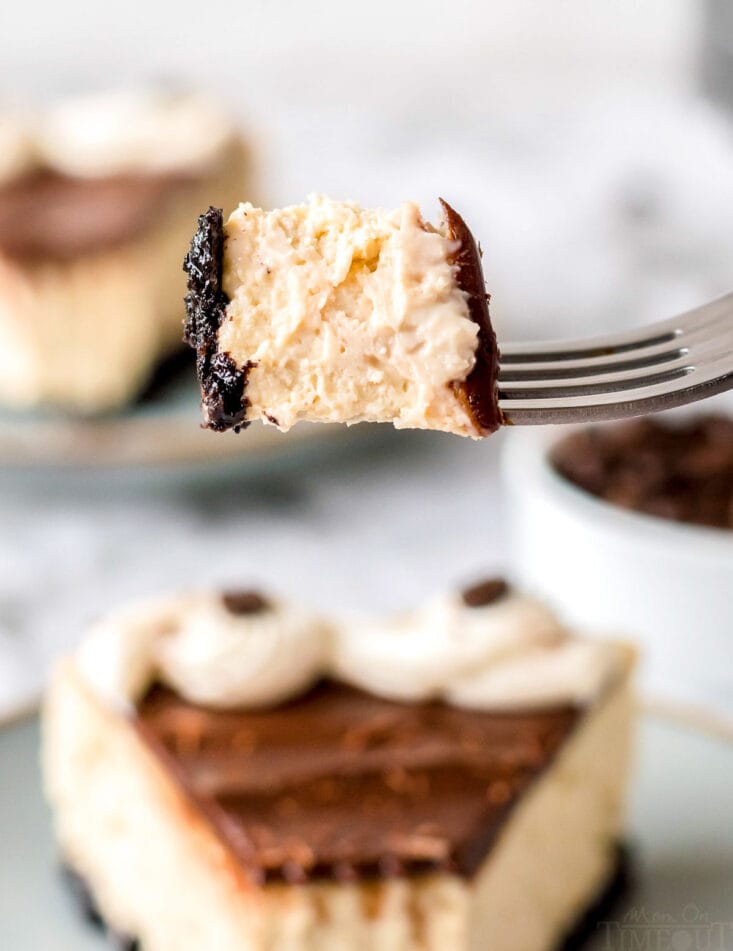 bite of espresso cheesecake recipe being held up with fork over a piece of cake