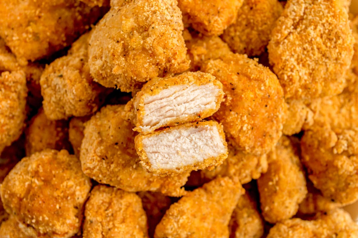 chicken nugget split in half on top of more nuggets.