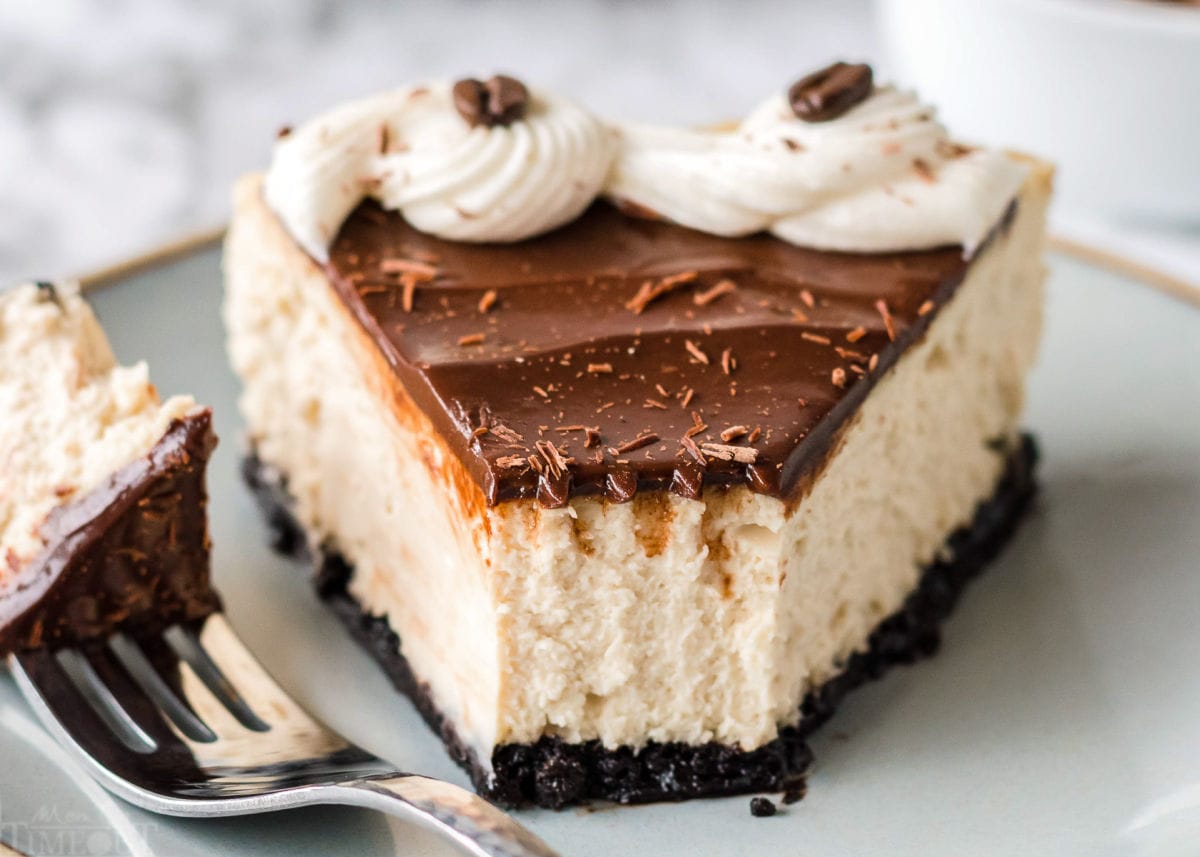 slice of espresso cheesecake with bite removed on pale green plate