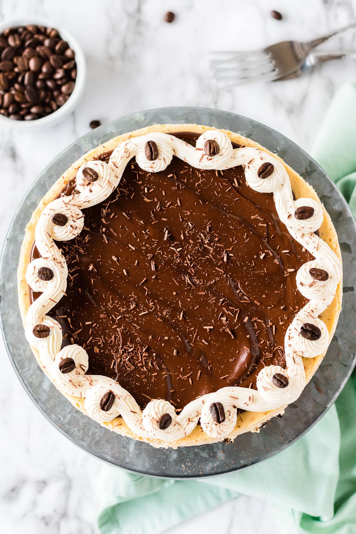 cheesecake topped with ganache and chocolate shavings