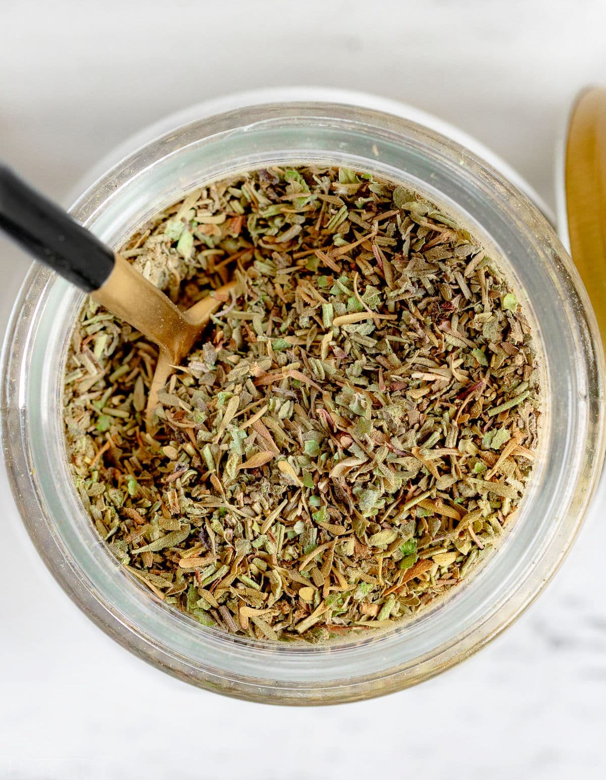 top down look at spices in a glass jar all mixed together.