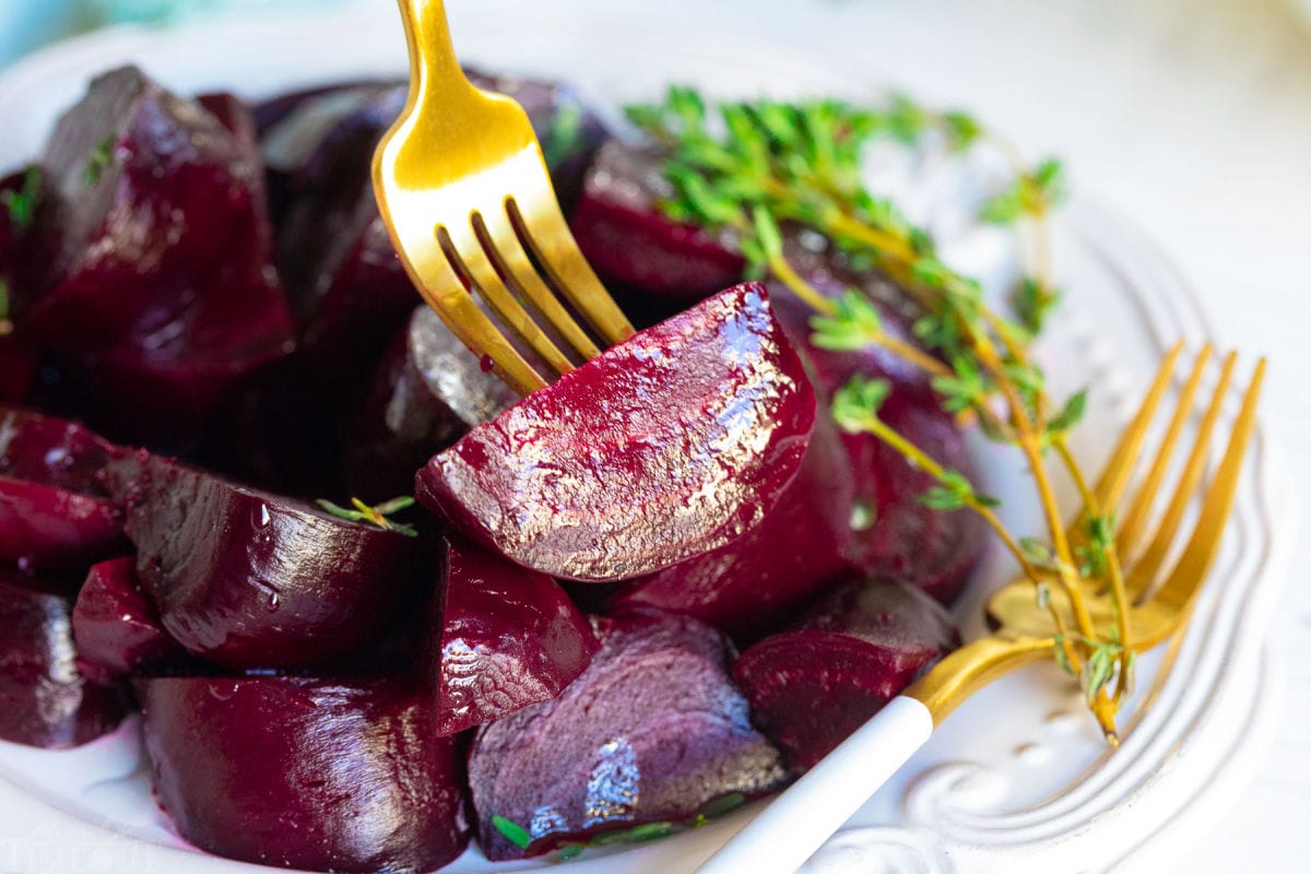 beet being picked up with gold fork.