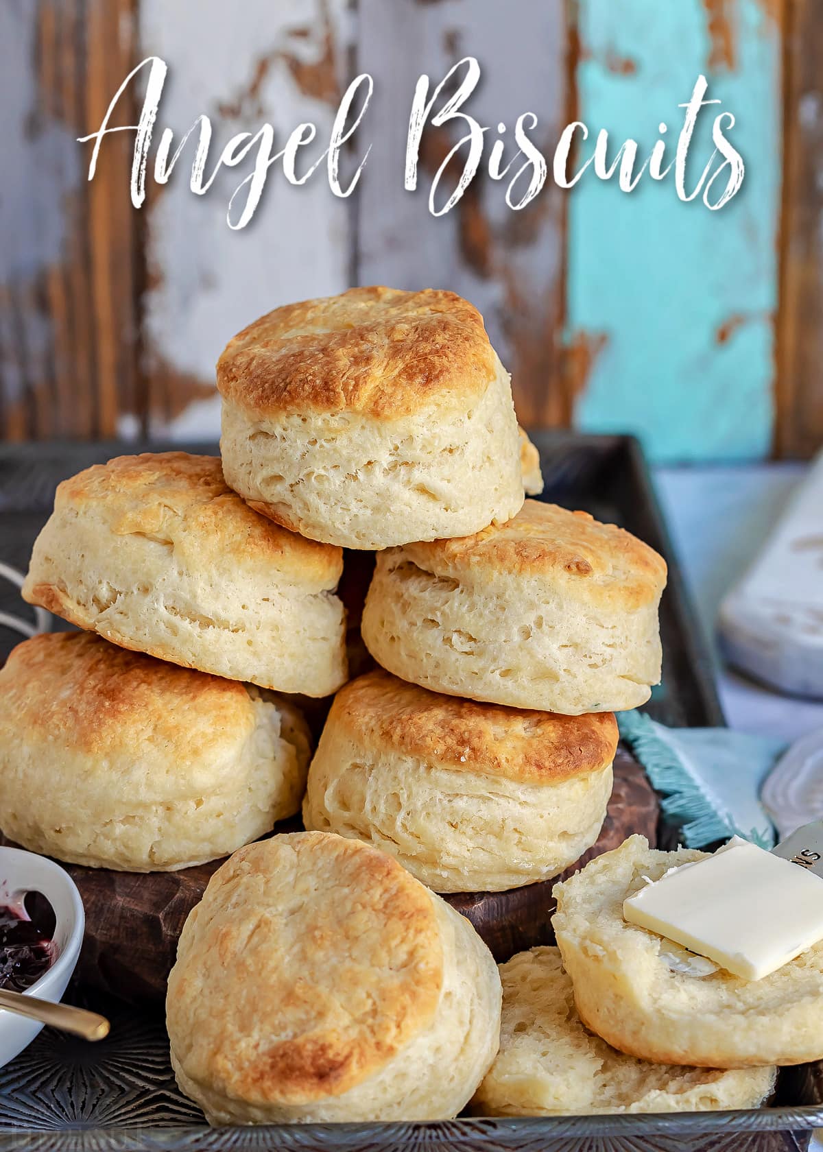 biscuits piled high in vintage sheet pan with title overlay at top of the image.