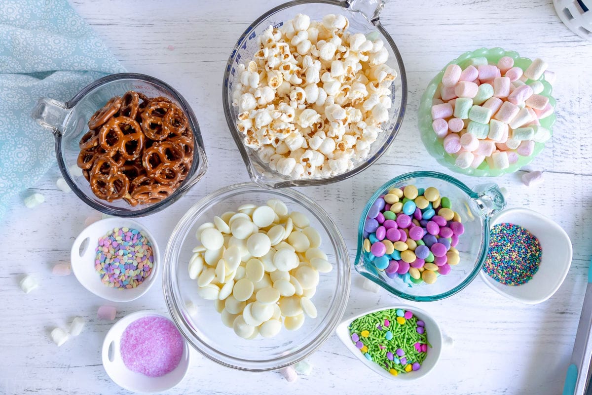 snack mix ingredients measured out into small bowls.