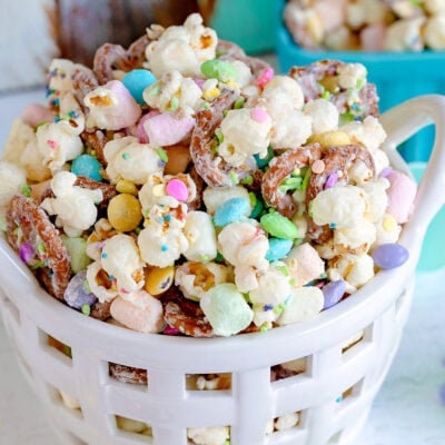 bunny bait snack mix with popcorn and pretzels in a white ceramic basket.