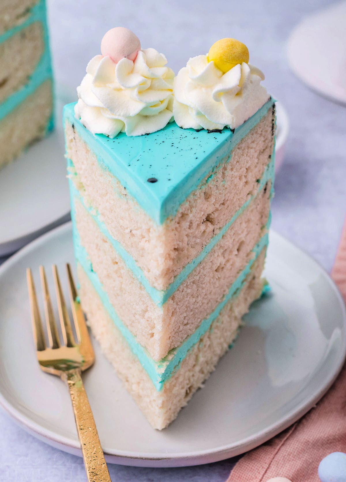 one slice of vanilla cake decorated with blue frosting and cadbury eggs.