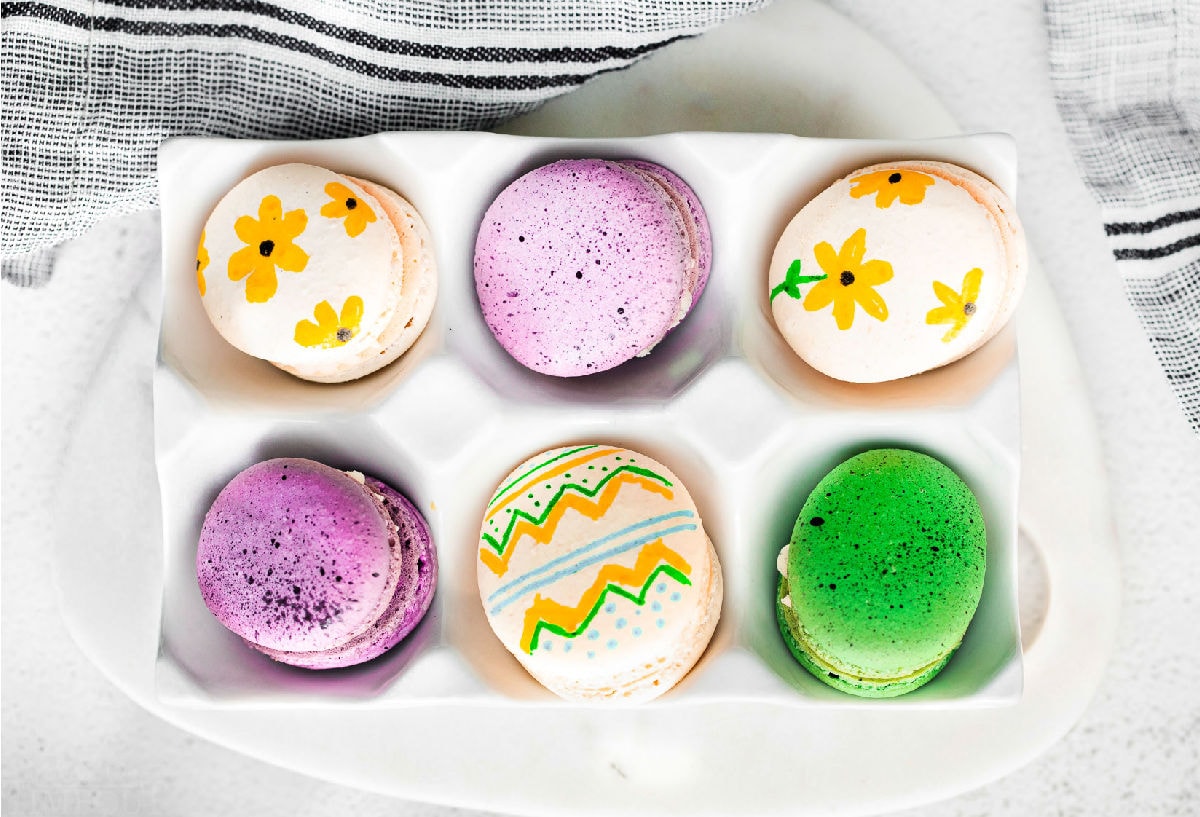 top down look at 6 decorated easter egg macarons.