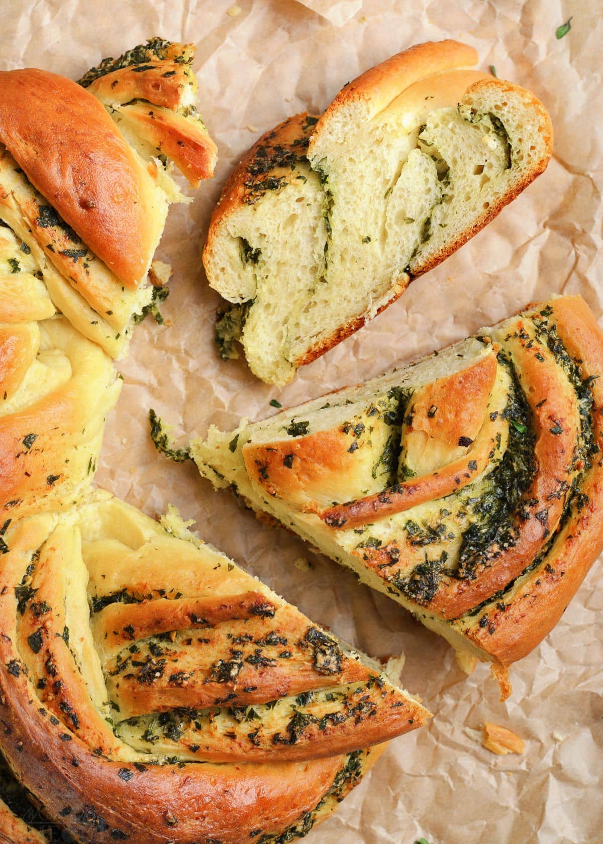 top down view of garlic herb bread with pieces cut.