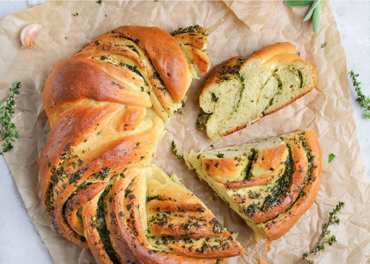 top down view of garlic herb bread wreath with 2 pieces cut.