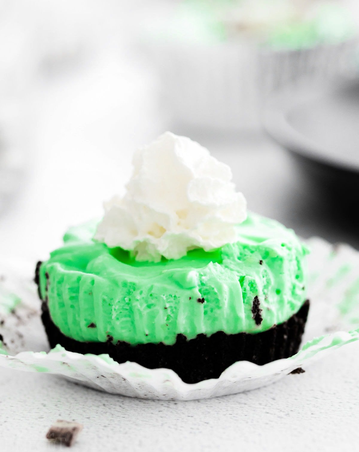 mini cheesecake flavored with creme de menthe liqueur with an oreo crust and topped with whipped cream.