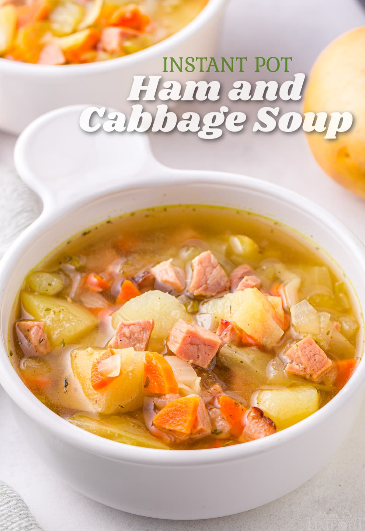 white bowl of cabbage soup with ham and title overlay at top of image.