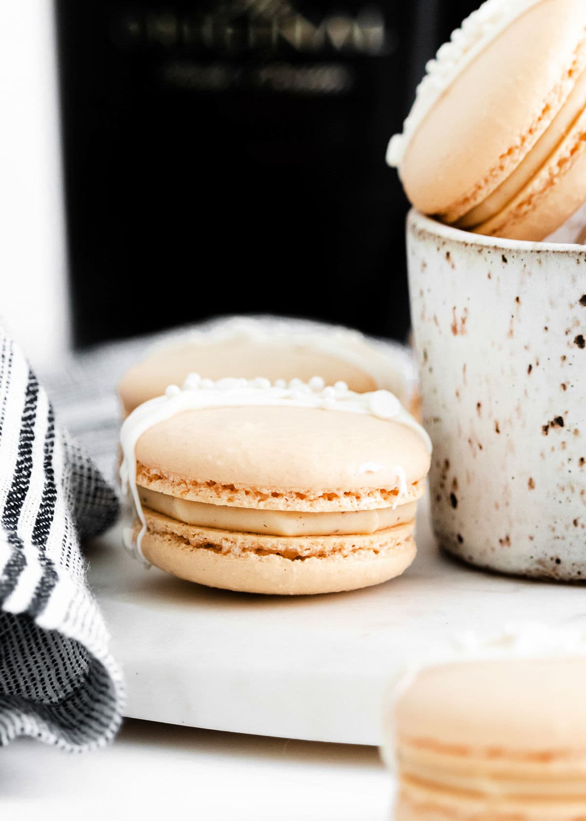 close up look at Irish cream macarons with drizzle on top.