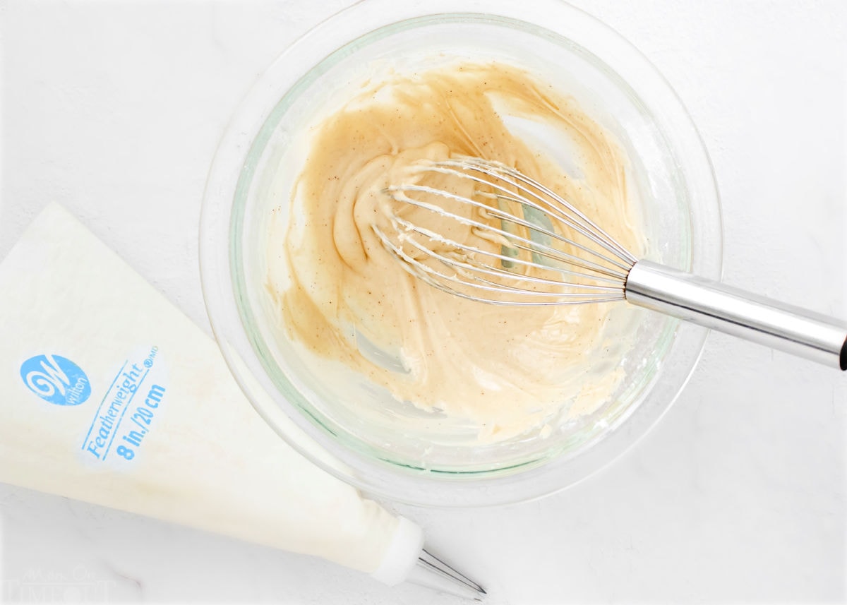 irish cream filling in glass bowl with whisk.