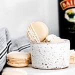 irish cream macarons next to bottle of baileys.