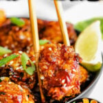 piece of teriyaki chicken being picked up out of a bowl with chopsticks. color block and text at top of image.