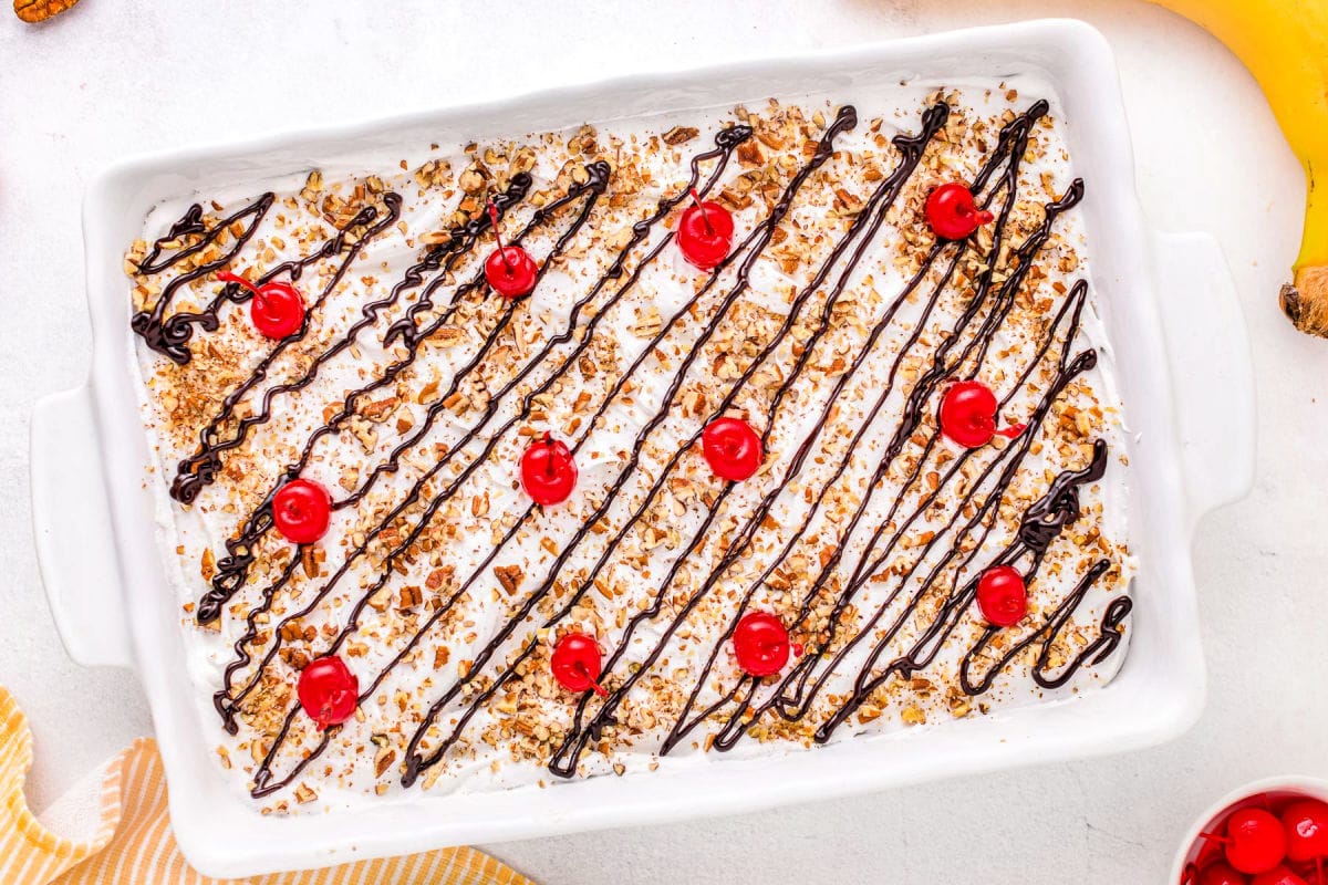 top down look at banana split dessert in white baking dish.