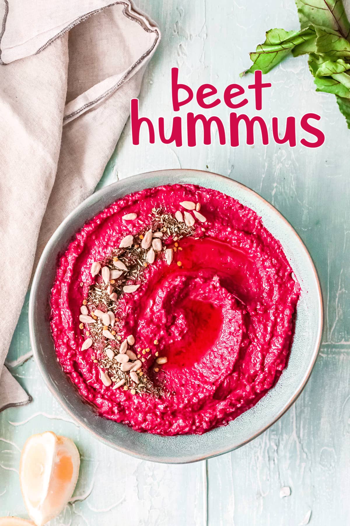 beet hummus in a light blue bowl with a beige napkin to the side and a title overlay at the top.