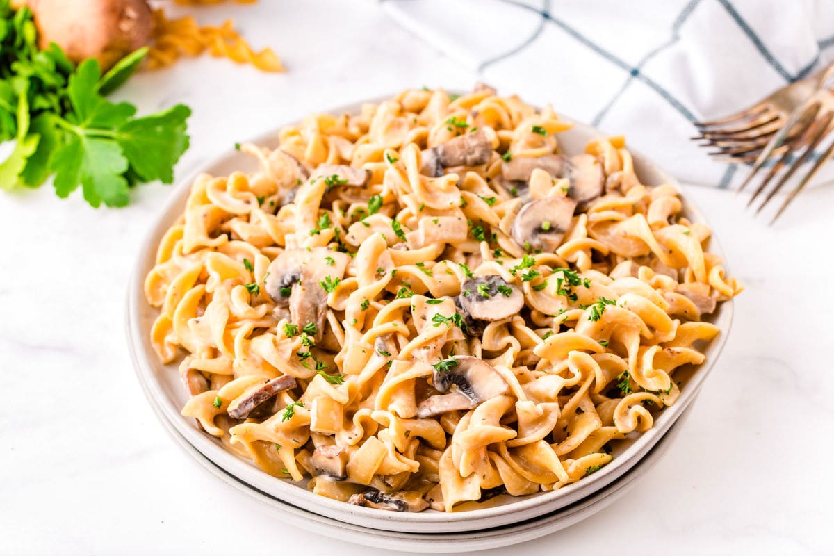 full plate of mushroom stroganoff garnished with parsley.