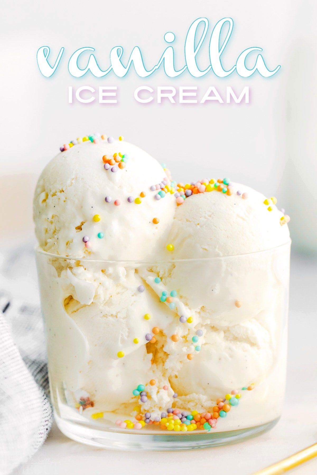 three scoops of vanilla ice cream in glass cup with sprinkles on top. text overlay at top of image.