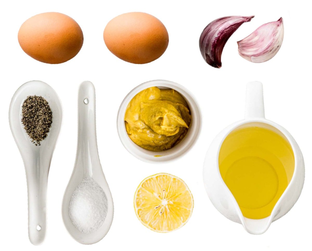 aioli ingredients measured out in small bowls on white background.