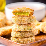 air fryer pickles stacked 5 high with the top pickle bitten in half.