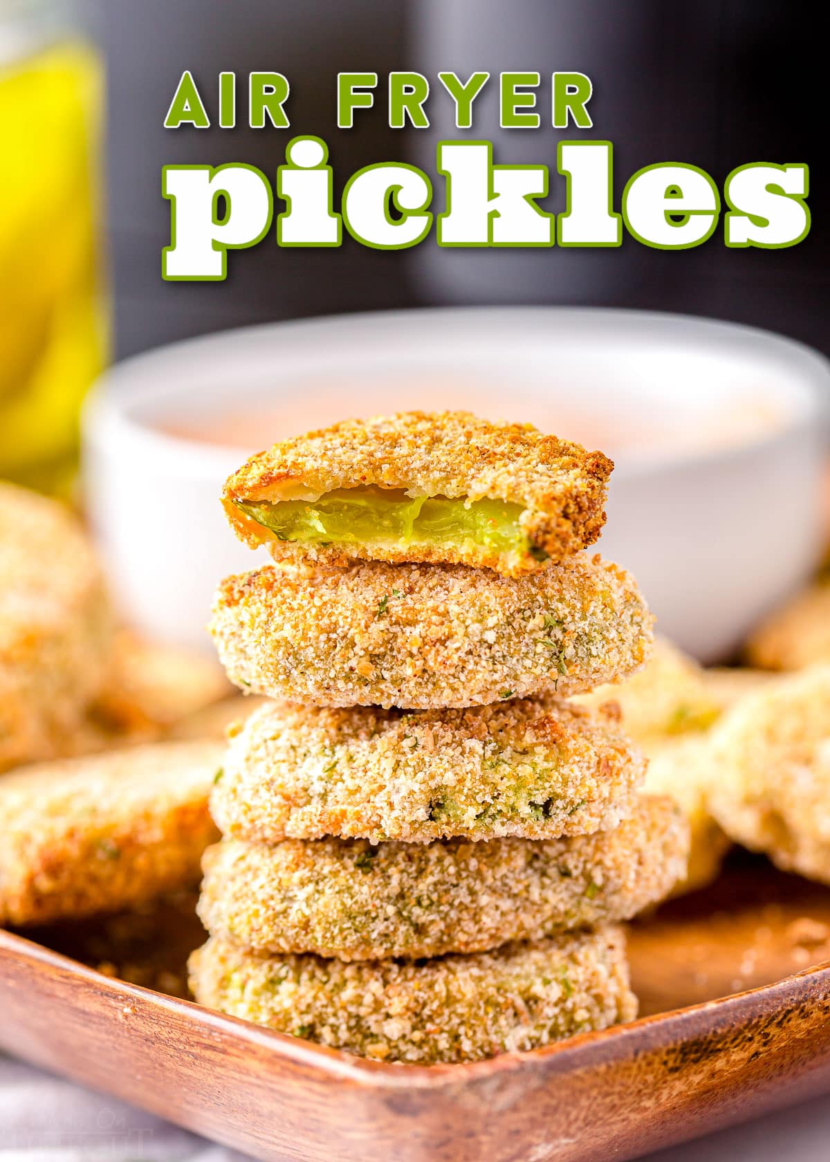 air fryer pickles stacked 5 high with the top pickle bitten in half. title overlay at top of image. 