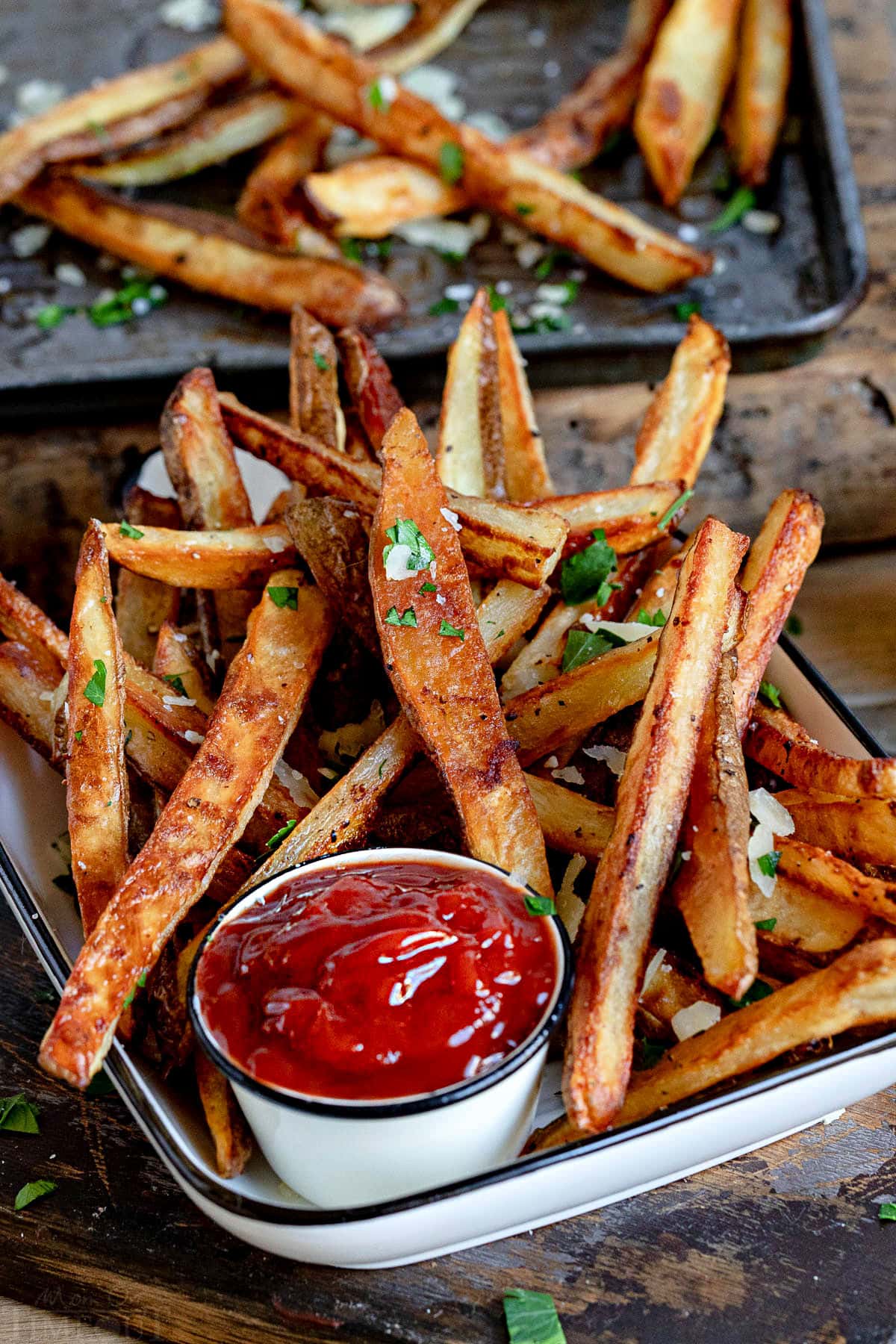 perfectly crisp oven fries piled high with Parmesan cheese and parsley. Served with ketchup on the side.