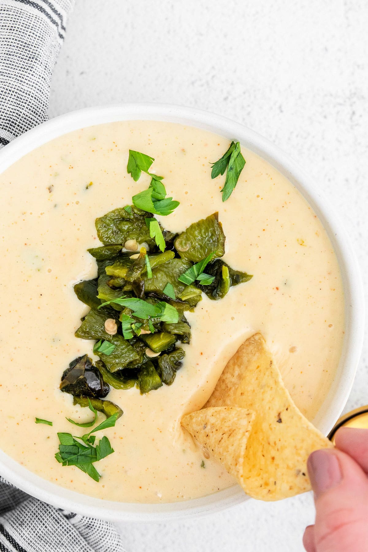 large bowl of queso whip chip being dipped.